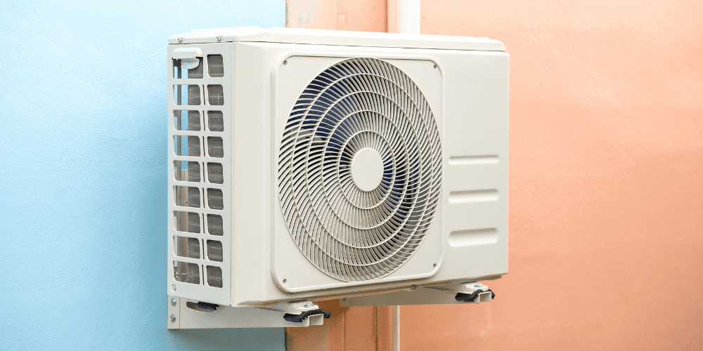 aircon attached on a blue and pink wall